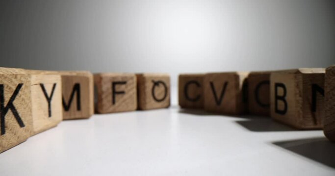 Wooden cubes with letters of English alphabet on table. Alphabet designed for children's games and skill development