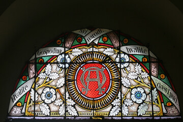 Alpha and Omega, stained glass window in the parish church of Saint Mary Magdalene in Prilisce,...