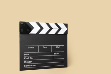 Cinema clapper board on a beige background, copy space, entertainment industry prop, media...