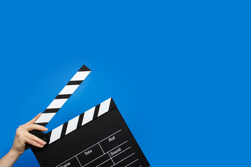 Hands with clapper board, video production, motion industry, film.