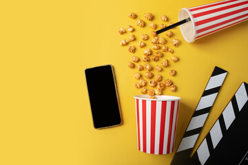 Cinema tickets online, Popcorn bucket with soda cup and clapper board with phone, mobile cinema...