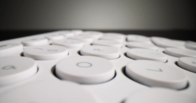 Closeup of white keyboard on black background. Darknet and shadow internet