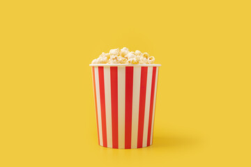 Popcorn bucket, striped box, film treat, crunchy snack,yellow background