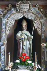 Naklejka premium Saint Martin statue at the main altar in the Parish Church of Saint Martin in Pisarovinska Jamnica, Croatia
