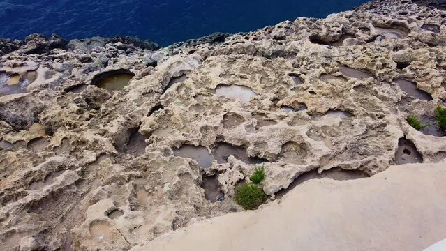 Blue mediterranean sea and rocky coast of Maltese island with Filfla uninhabited island in the distance. High quality 4k footage
