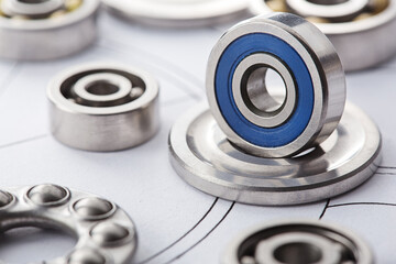 different bearings on blue print background. Part of mechanism.