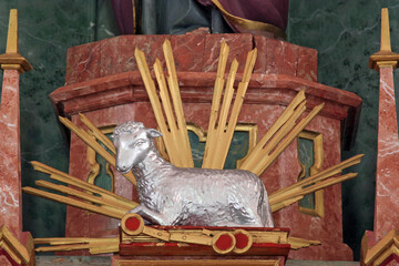 Agnus Dei, Lamb of God, statue on the High altar in the parish church of Saint Luke in Lukac,...