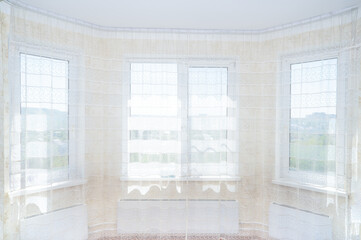 Sunlight fills spacious room through large windows, creating bright, inviting space. softness,...