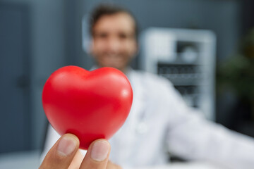 Doctor man holding red heart, Cardiology concept.