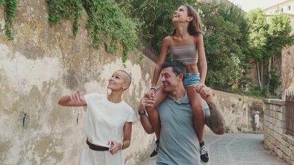 Beautiful happy family traveling, walking around the city and seeing the sights