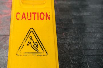 Worn-out wet floor warning sign.