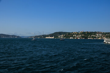 Fototapeta premium Turquoise blue sea water. View of the Bosphorus in Istanbul city on sunny summer day, in a public place.