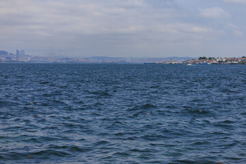 Turquoise blue sea water. View of the Bosphorus in Istanbul city on sunny summer day, in a public place.