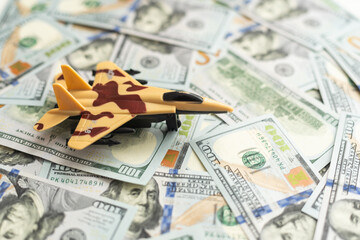 Military toy airplane jet aircraft - on money background