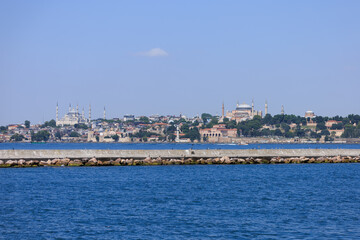 Fototapeta premium Blue seascape overlooking the coast. View of the Bosphorus in Istanbul city on sunny summer day, in a public place.