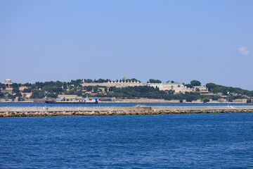 Fototapeta premium Blue seascape overlooking the coast. View of the Bosphorus in Istanbul city on sunny summer day, in a public place.