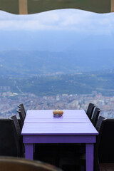 Beautiful views from above, tables in a cafe in the mountains and a panoramic view of the city, public places in Turkey, on a sunny summer day