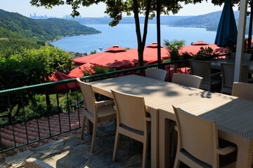 Beautiful views from above, tables in a cafe in the mountains and a panoramic view of the city, public places in Turkey, on a sunny summer day