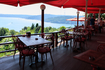 Beautiful views from above, tables in a cafe in the mountains and a panoramic view of the city, public places in Turkey, on a sunny summer day