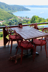 Fototapeta premium Beautiful views from above, tables in a cafe in the mountains and a panoramic view of the city, public places in Turkey, on a sunny summer day