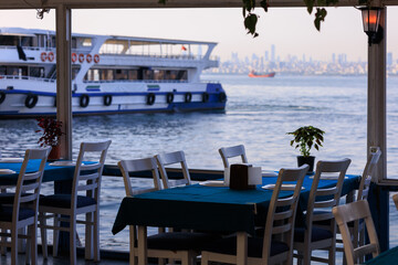 Beautiful views from above, tables in a cafe in the mountains and a panoramic view of the city, public places in Turkey, on a sunny summer day