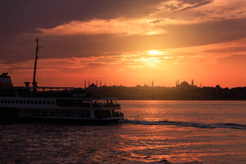 Fototapeta premium Orange sky at sunset in the evening. Seascape overlooking the coast in the city of Istanbul