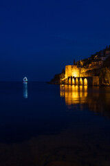 Night view of the city. Black and blue sky, illumination and city streets.