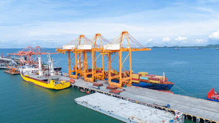 Crane loading box container to cargo ship at commercial dock port. Shipyard Cargo Container Sea...