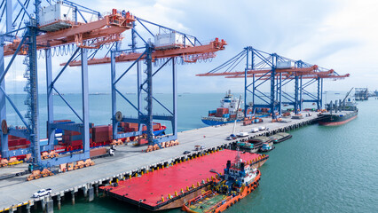 Crane loading box container to cargo ship at commercial dock port. Shipyard Cargo Container Sea...