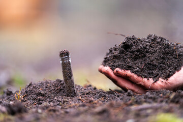 turning a compost pile in a community garden. compost full of microorganisms. sustainable...
