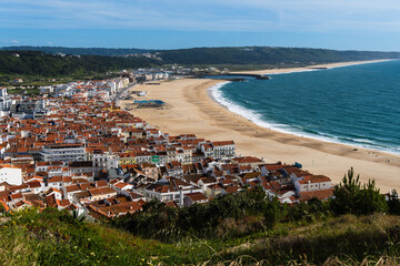 View from the hill to the sandy beach 'Praia da Nazaré' , Praia do Norte beach and Nazare town, Portugal