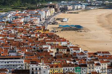 Fototapeta premium View from the hill to the sandy beach 'Praia da Nazaré' , Praia do Norte beach and Nazare town, Portugal