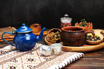 herbal tea and ingredients on wooden table