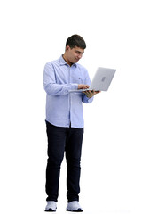 A man, full-length, on a white background, uses a laptop