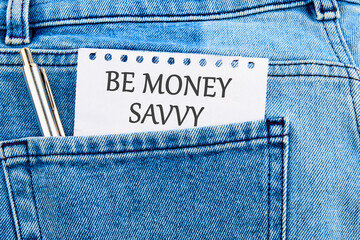 Savings concept,Text Be money savvy on a piece of paper that appeared from the pocket of jeans