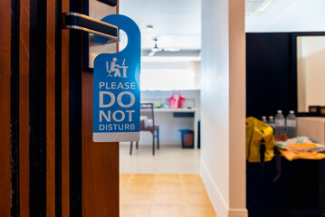 Please do not disturb sign tag hanging at hotel open door.