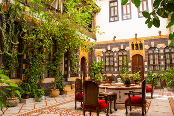 Interior of luxury hotel in oriental style with living plants and fountain in the lobby