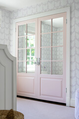 Luxury Pink Double Doors Open to A Bright Room with Mirror Panels