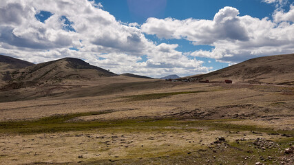 high altitude mountain with shadow of cloud and little plant in eastern tibet