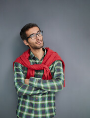 Stylish young man posing in the studio on gray background