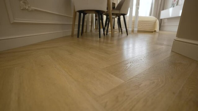 Quartvinyl tiles in a new apartment. Bottom corner of quartz vinyl floor. Beautiful parquet floors in a new home.