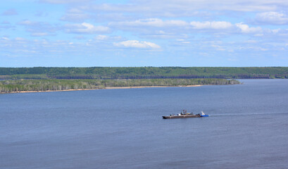 a ship is in the water with an island on the background 