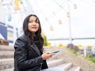 Travel lifestyle urban tourist, happy young girl using smartphone in Osaka Japan.