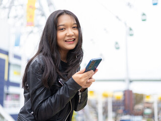 Travel lifestyle urban tourist, happy young girl using smartphone in Osaka Japan.
