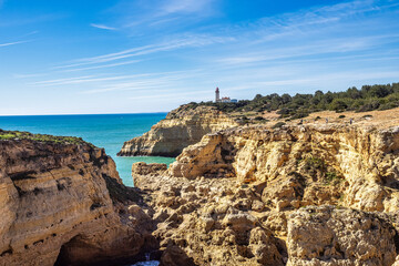 Portuguese coast in Benagil, Algarve, Portugal. Alfanzina Lighthouse. Seven Hangging Valleys Trail.