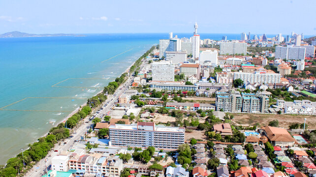 Aerial view of coastal city with highrise buildings and beachfront, creating urban landscape