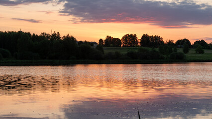 colorful sunrise, sunset landscape by the lake, brightly colored sky is reflected in the water of the lake