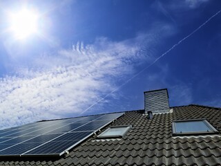 Solar panels producing clean energy on a roof of a residential house