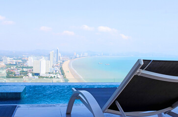 Enjoy the picturesque beach view while you unwind next to the pool at a luxurious hotel