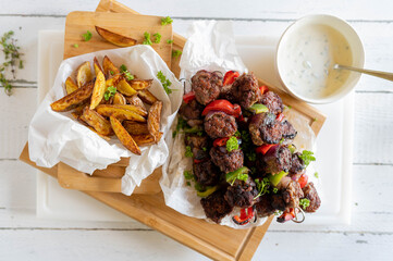Balkan minced meat skeweres with potato wedges
